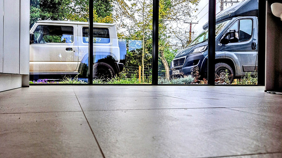 Full-height aluminium glazing at floor level in a finished interior