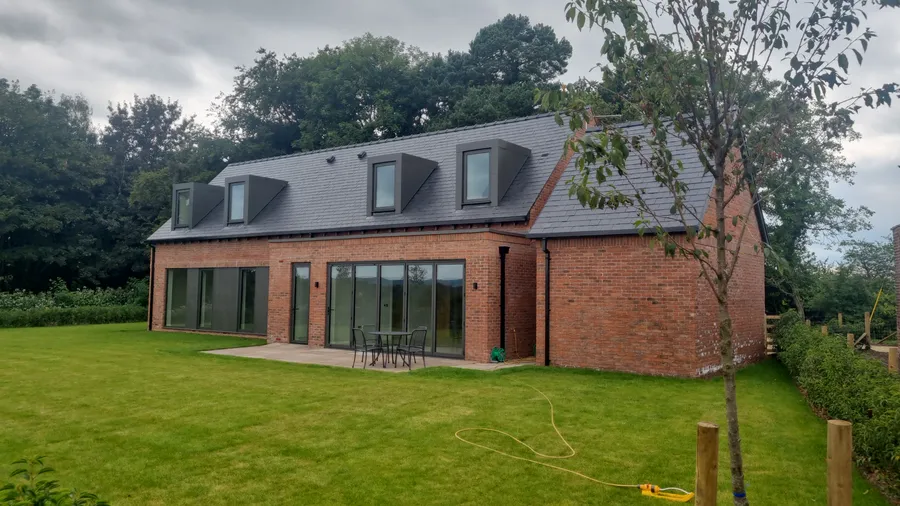 Completed North West new build with VitrineAlu anthracite aluminium bifold doors, windows and dormers