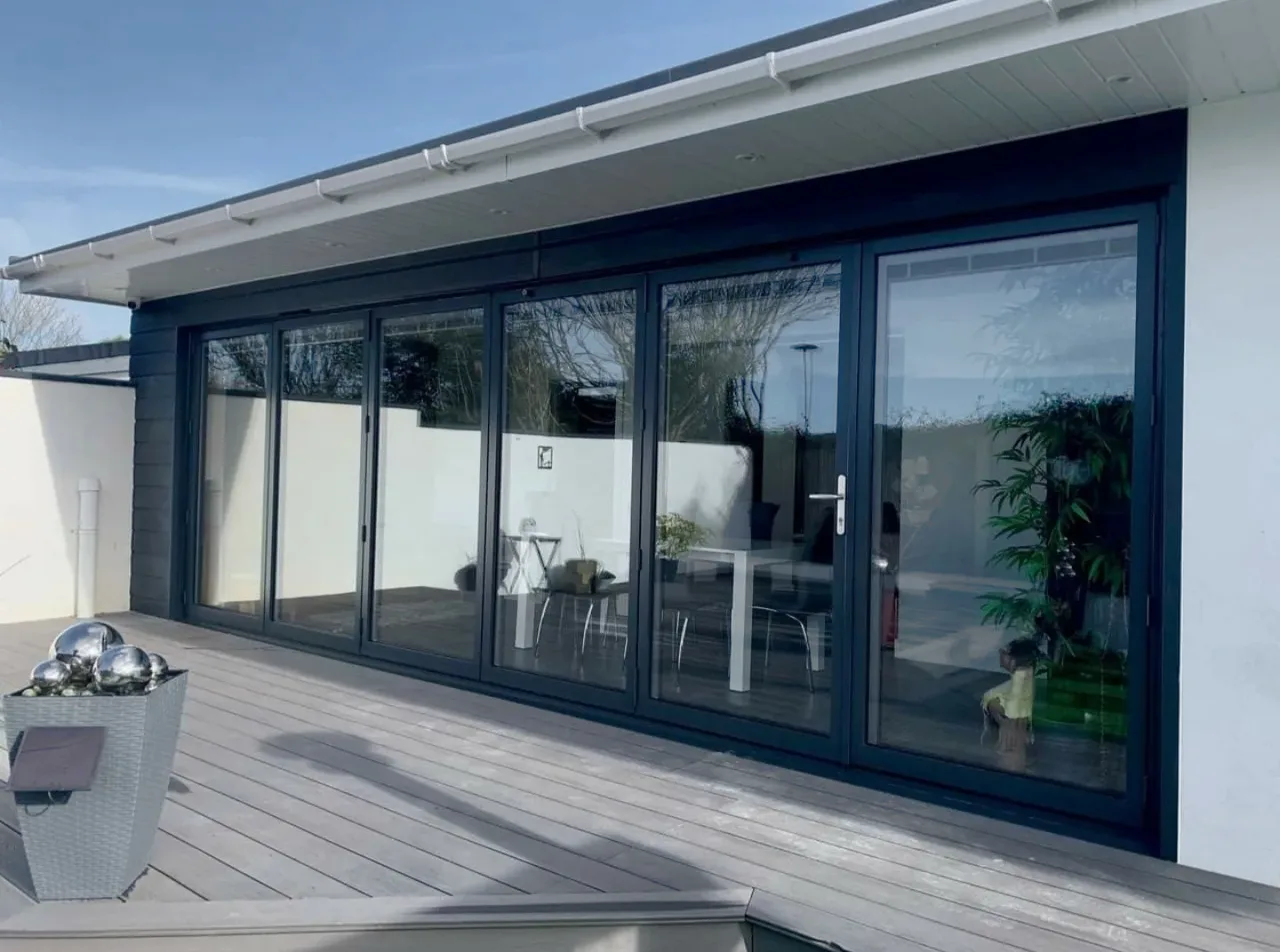 Aluminium bifold doors meeting a paved patio at the threshold