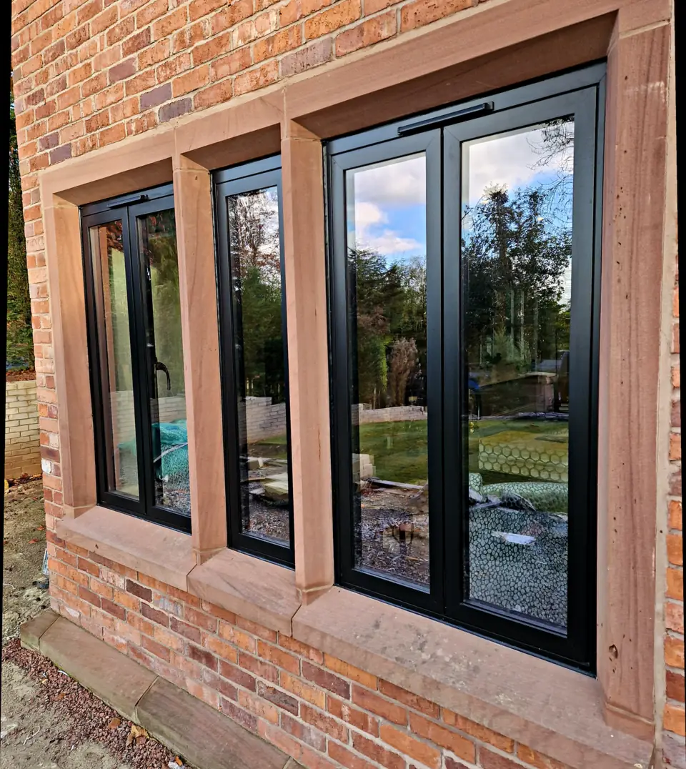 Run of casements across a brick facade