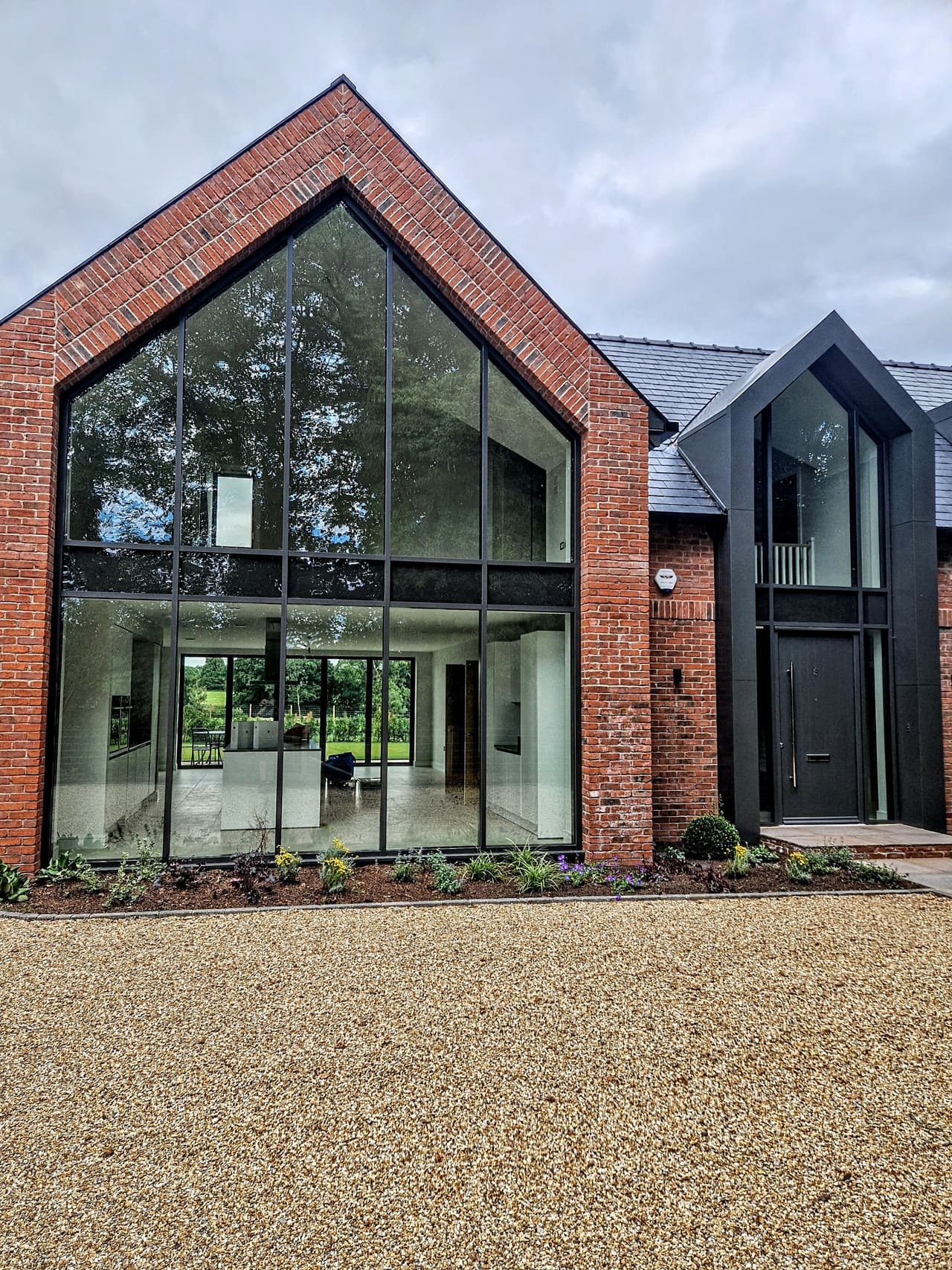 Black aluminium full-height glazing on a modern detached house — VitrineAlu, North West England