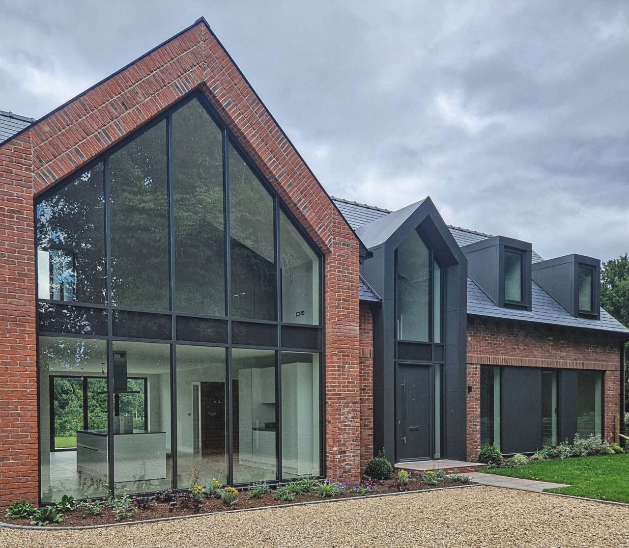 A traditional brick house elevation with a closed solid back wall — VitrineAlu project, North West England